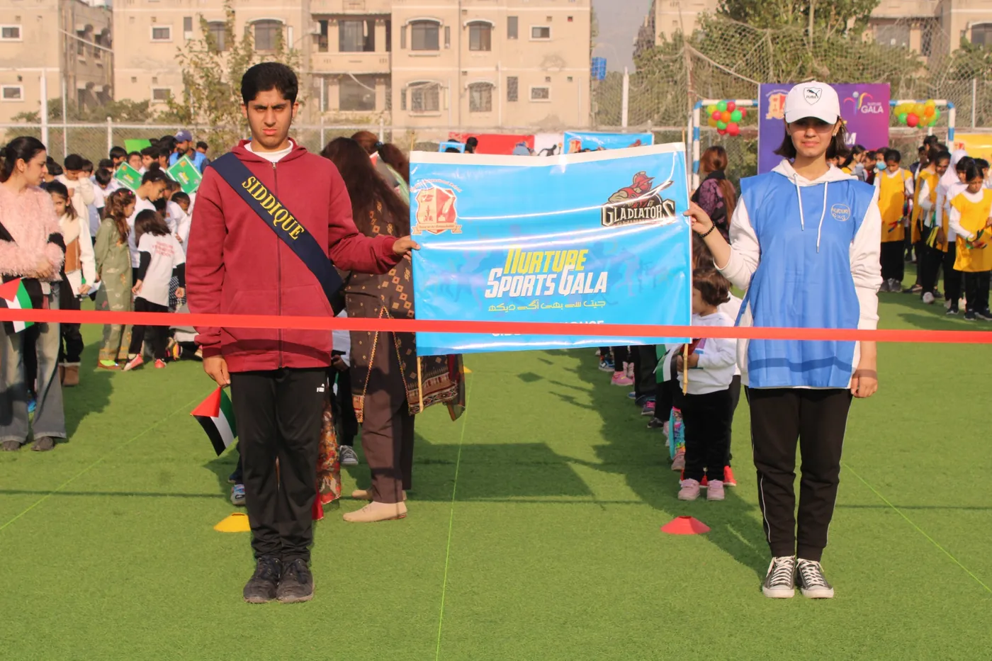 Students opening a Nurture sports gala on the outdoor campus field