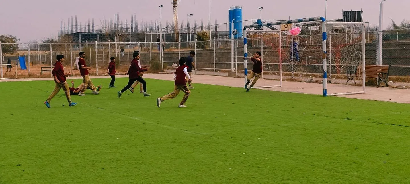 Students playing football on the Nurture sports field